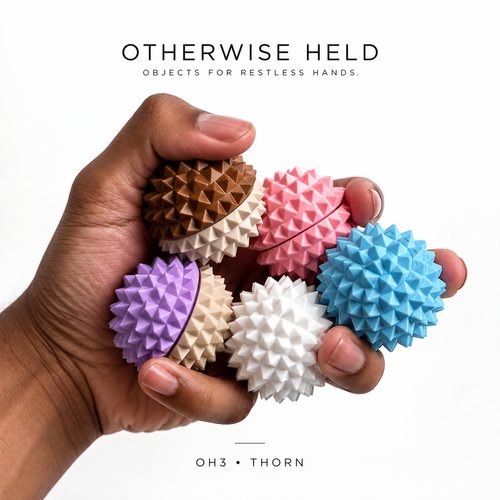 Hand holding five OH 03 Thorn spiky fidget clickers in five colors