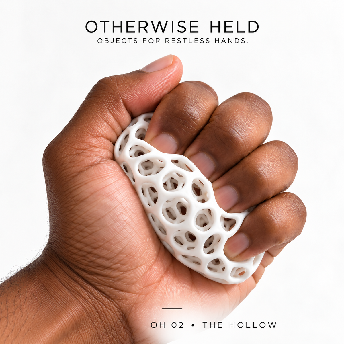 Hand squeezing a white OH 02 The Hollow ball