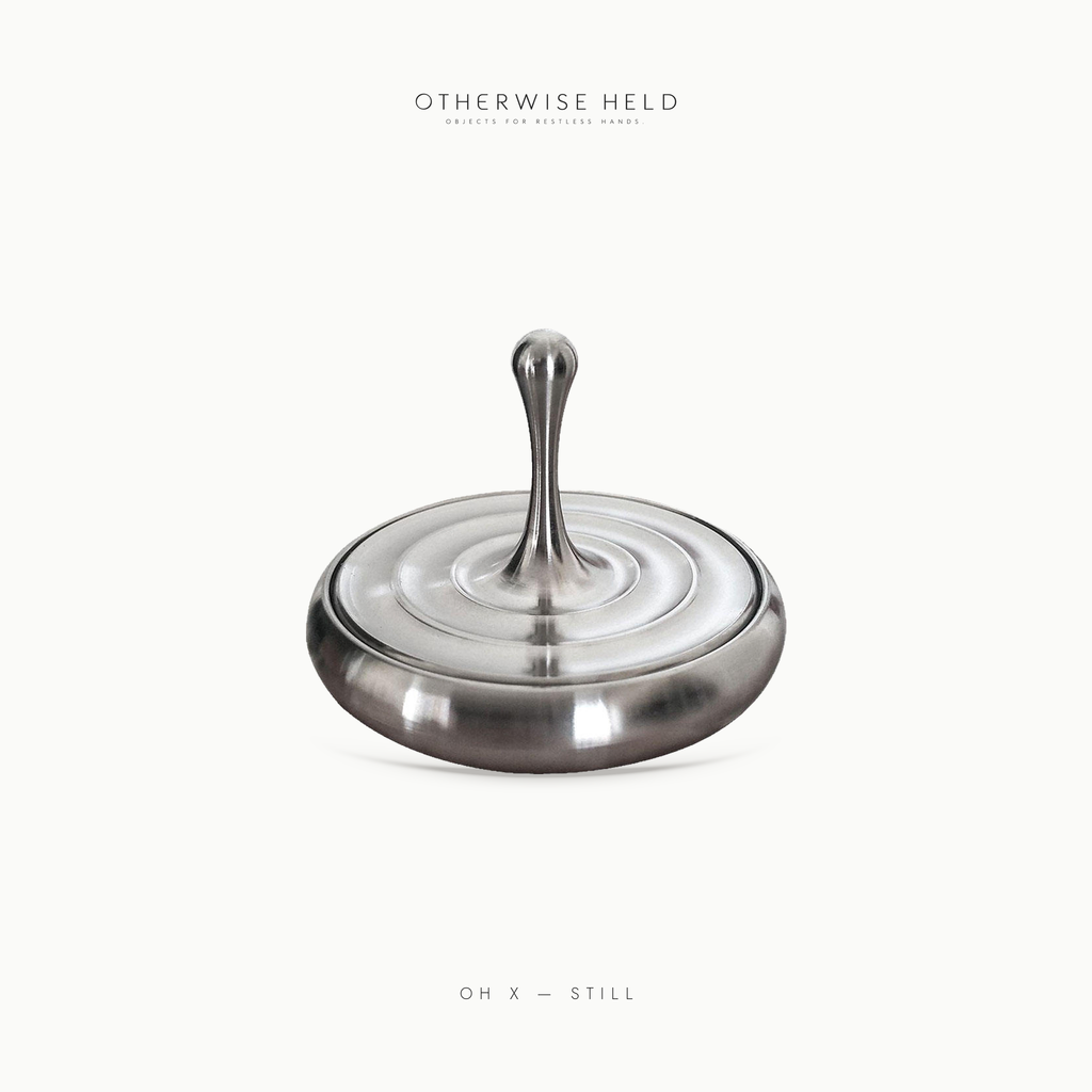 OH X Still premium stainless steel water drop spinning top on rippled base, desk fidget for adults
